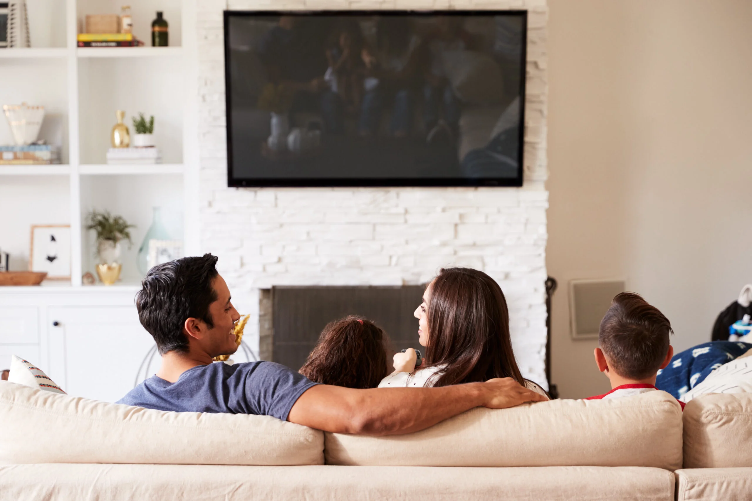 Latino family watching Dish TV from a selection of Dish Latino channels.